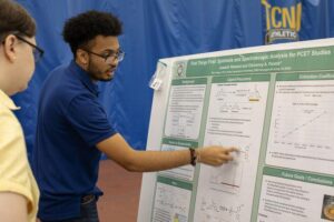 student presents at poster session